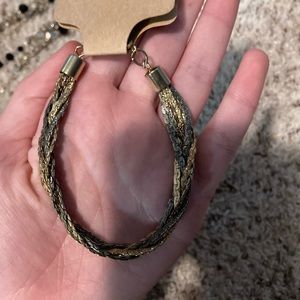 Brand new bracelet coloring the bracelet dark gray/black and gold color.